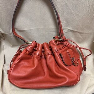 Ellen Tracy red leather drawstring bucket bag.